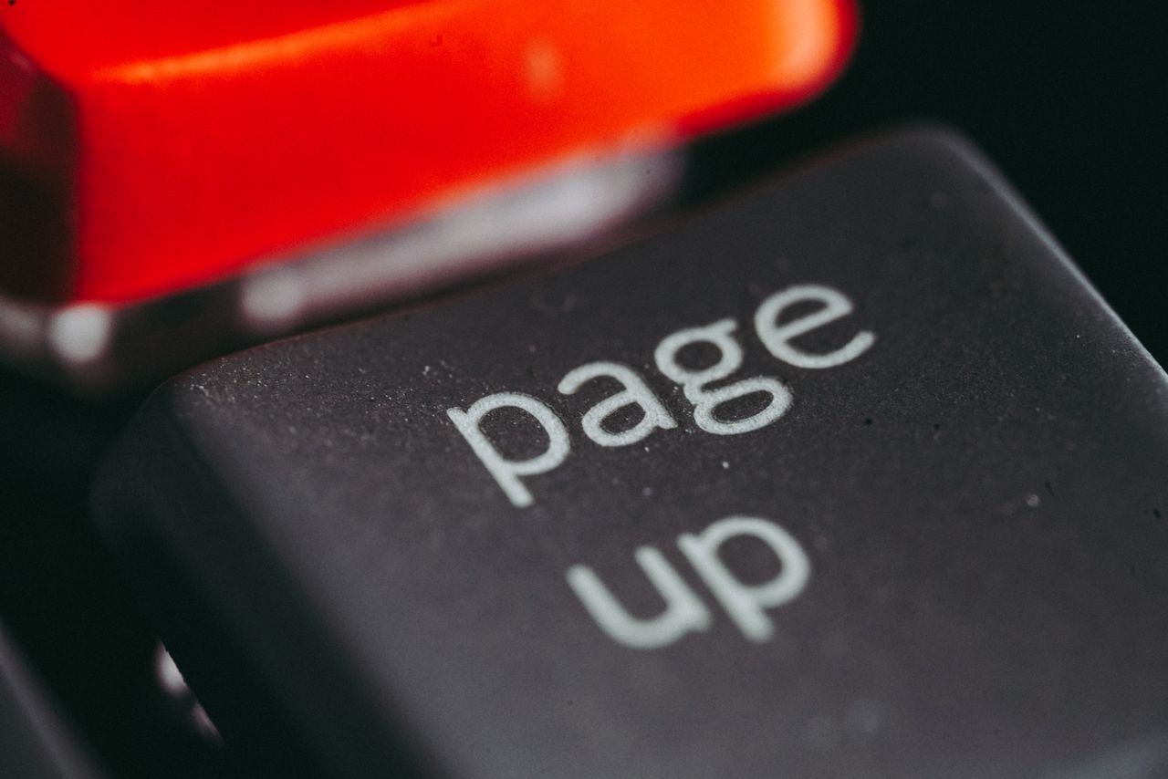 Close-up macro photography of a keyboards page up key, highlighting its texture and design.